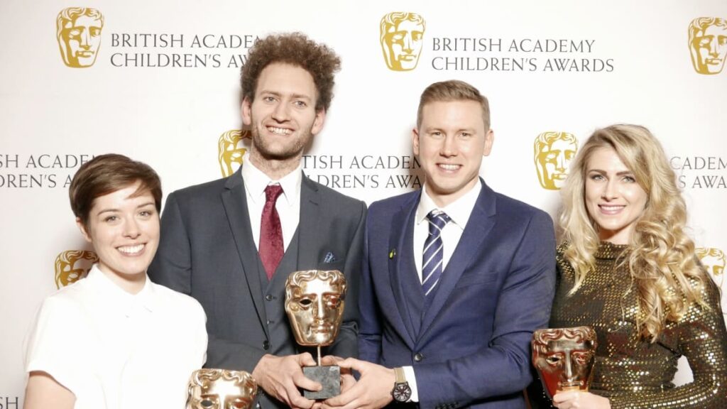 A picture of the BAFTA award-winning online history learning website History Bomb's team holding the BAFTA award